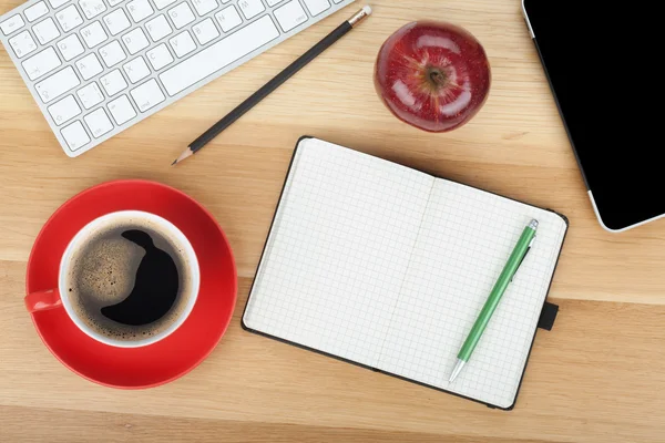 Coffee cup, red apple and office supplies