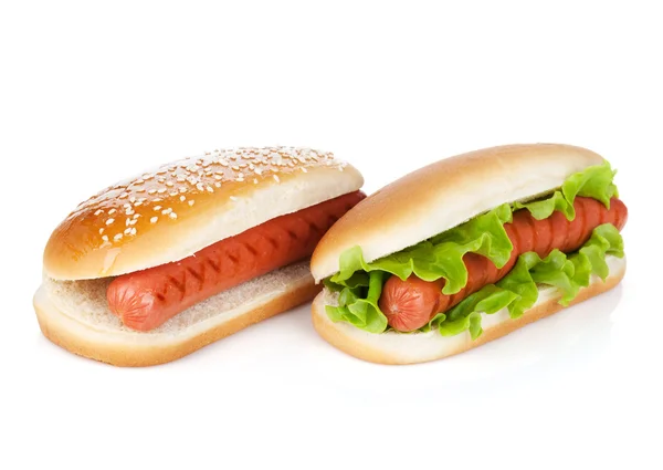 Two hot dogs with various ingredients