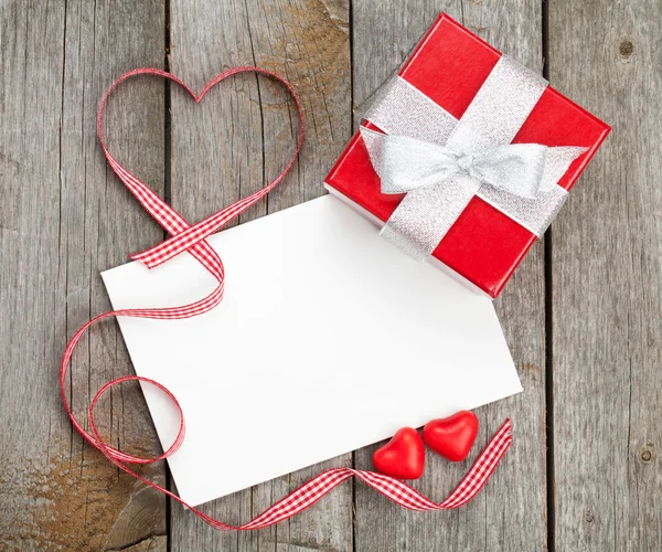 Greeting card and small red gift box