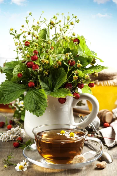 Bouquet of wild strawberry with herbal tea and honey