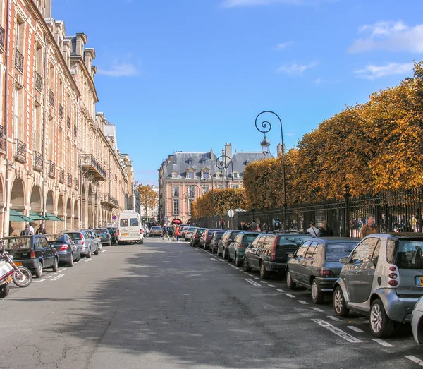 PARIS - OCT 3: Tourists walk in Place des Vosges, famous city sq