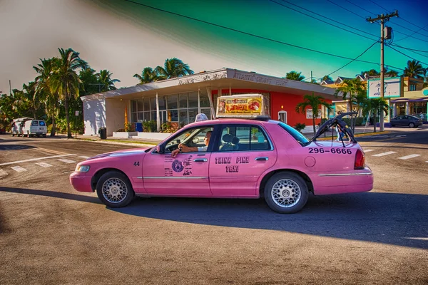 KEY WEST, FLORIDA - JAN 7: Pink taxi speeds up on city streets,