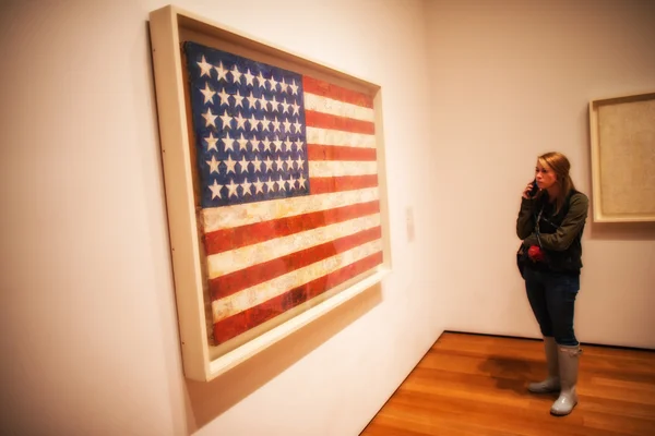 NEW YORK - JUN 10: Girl observes American flag canvas at Moma Mu