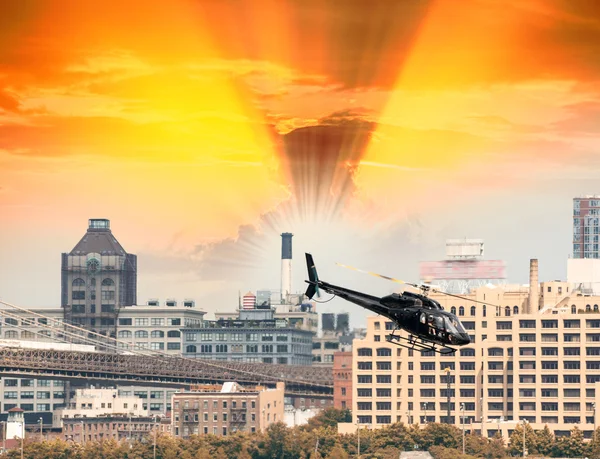 Black Helicopter hovering over New York buildings