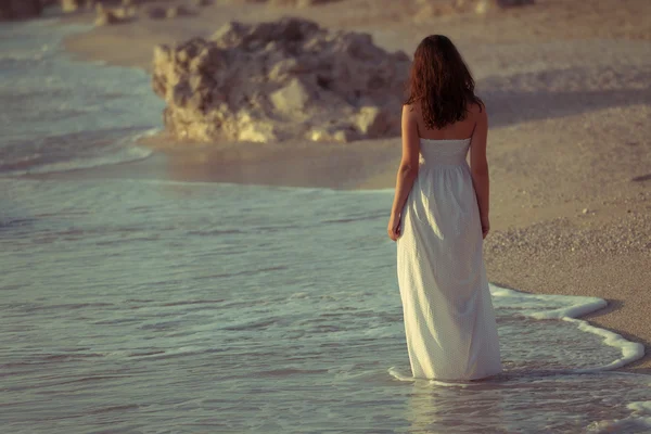 A girl walking on a beach