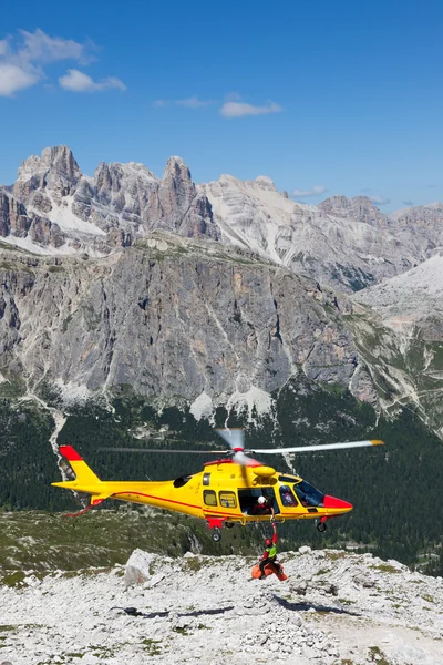 Mountain rescue with a Helicopter in the Alps.