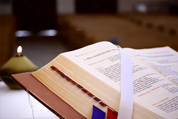 Bible and candle in a church