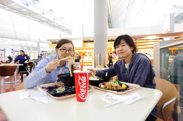 Korean girl eat Japanese food in Hong Kong International Airport