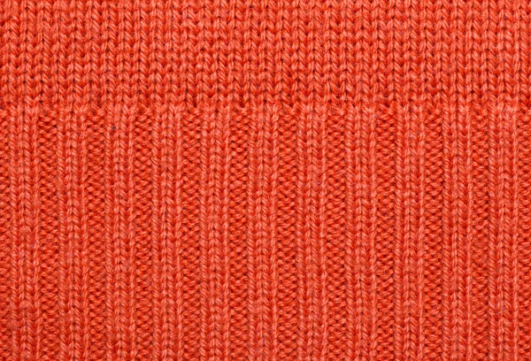 Red knitted fabric texture. Abstract background.