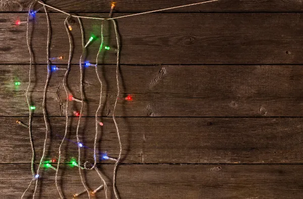 Christmas lights on a wooden background with copy space