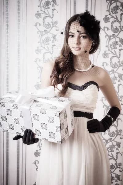 Beautiful vintage woman holding gift
