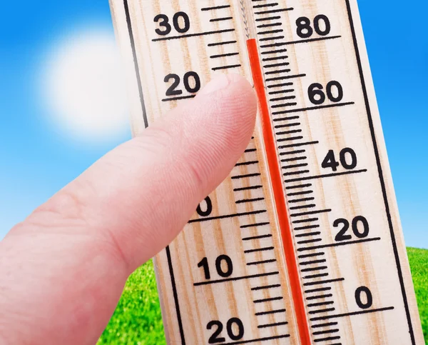 Thermometer in hand, shows a strong heat