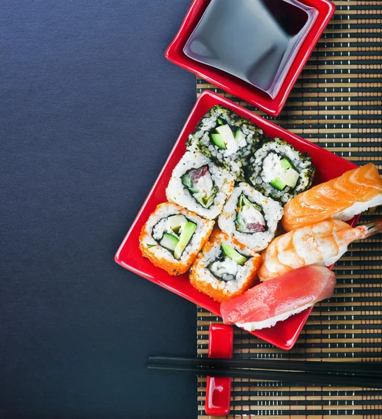 Sushi and chopstick on a black background for text