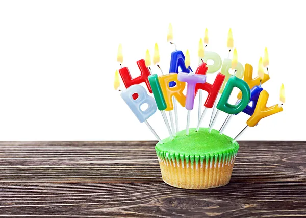 Colorful happy birthday cupcake with candles