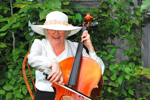 Mature female cellist.