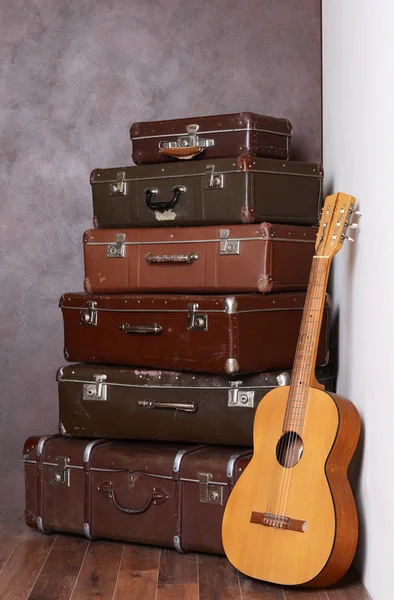 Old retro suitcases at a wall