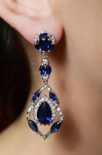 female ear in jewelry earrings