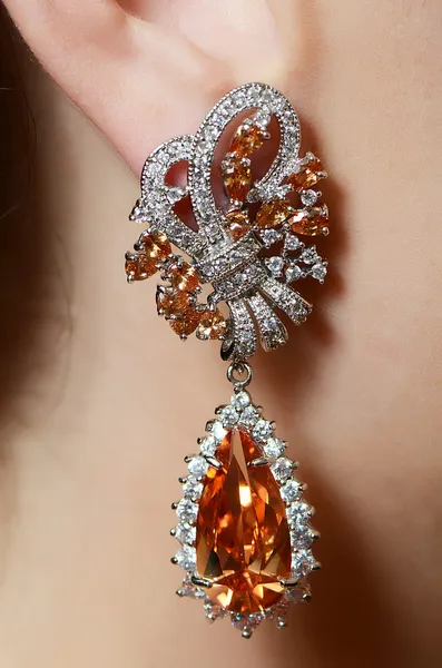 Female ear in jewelry earrings