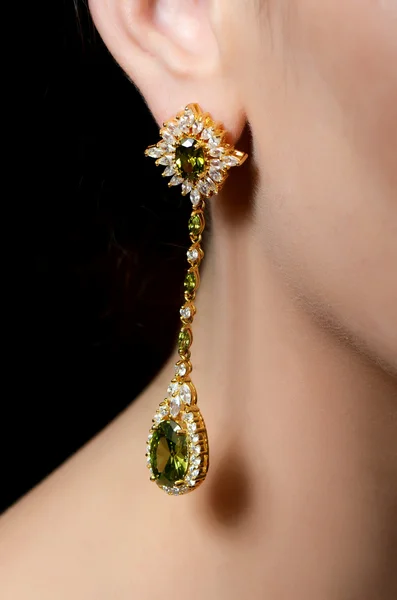 Female ear  in jewelry earrings