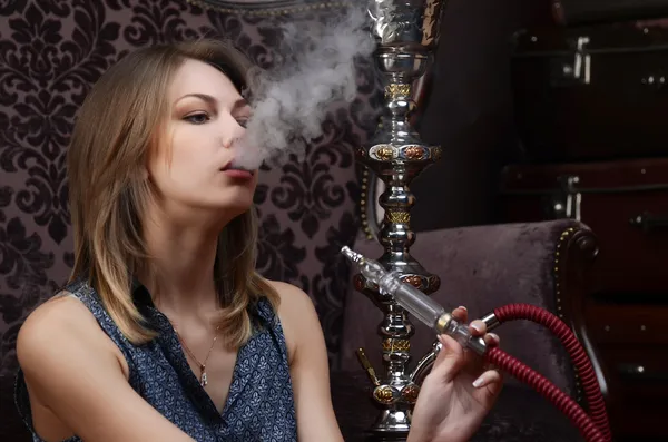 The beautiful woman with a hookah