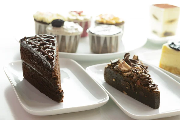 Assorted cake slices and cupcakes