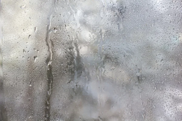Frozen drops on frosted glass. Winter textured background.