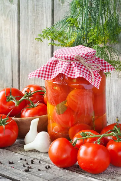 Homemade tomatoes preserves in glass jar. Fresh and canned tomat