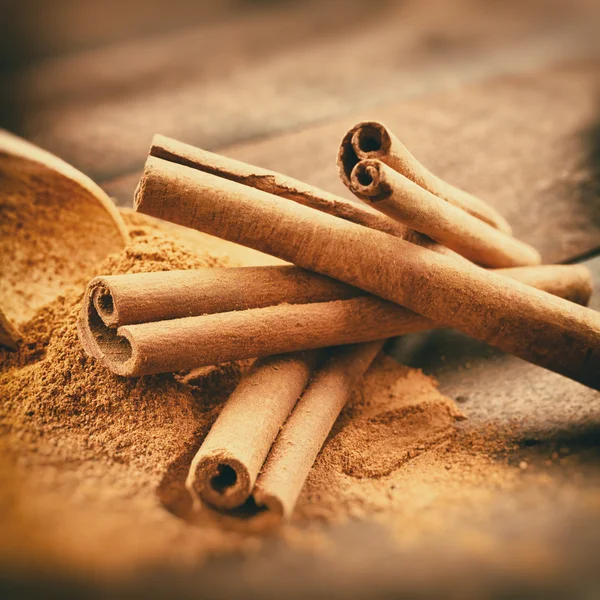 Vintage stylized photo of Cinnamon sticks and cinnamon powder