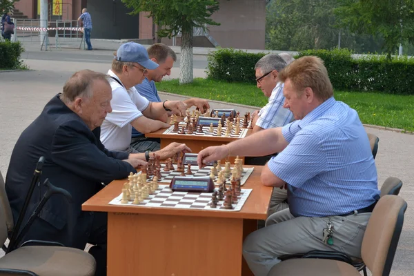 Street tournament on chess on a holiday day of the athlete. Tyum