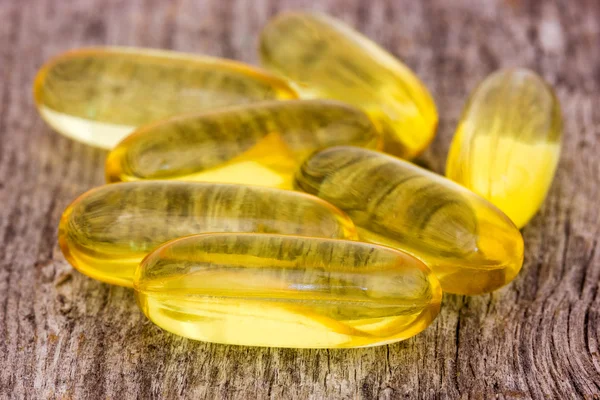Fish oil capsules on the wood