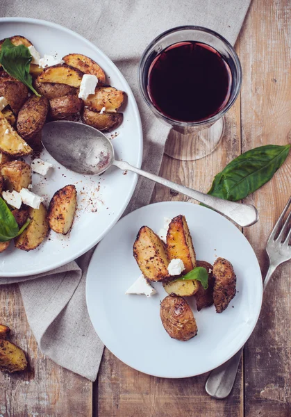 Homemade rustic dinner: a glass of wine and a baked potato — Stock Photo #30155377