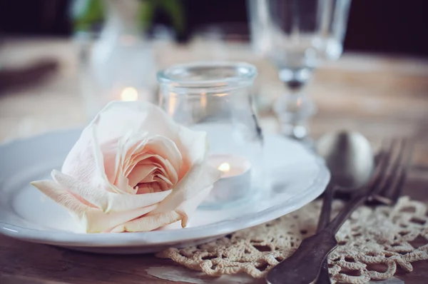 Vintage table setting with beige rose