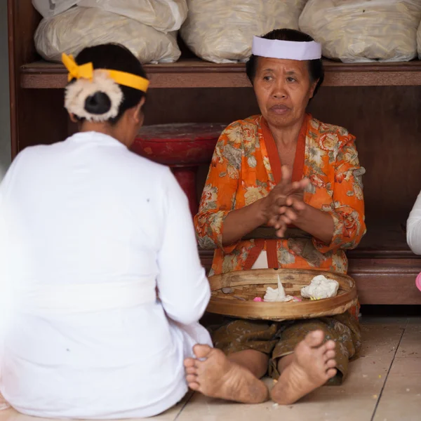 Balinese women make sweets for offerings