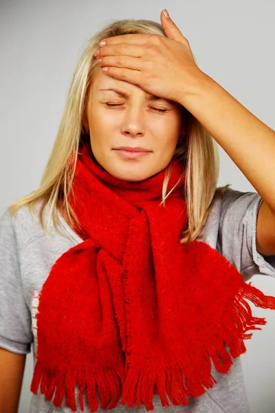 Young blond sick woman with headache