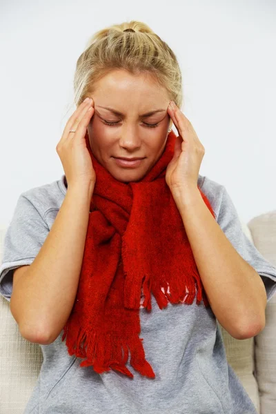Young blond sick woman with headache