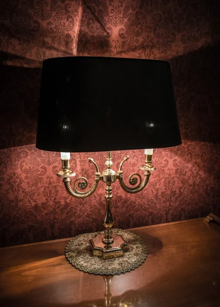 Vintage style lamp on a polished wooden table