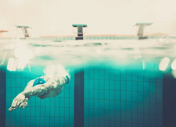 Swimmer under water in swimming pool
