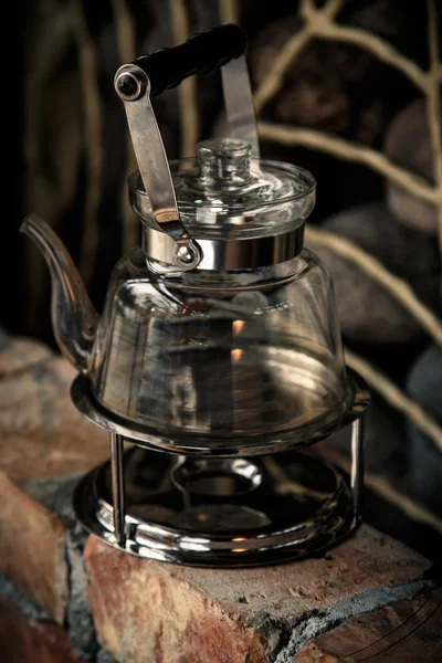 A glass kettle on a camping burner