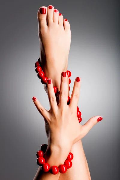 closeup photo of a beautiful female feet with red pedicure