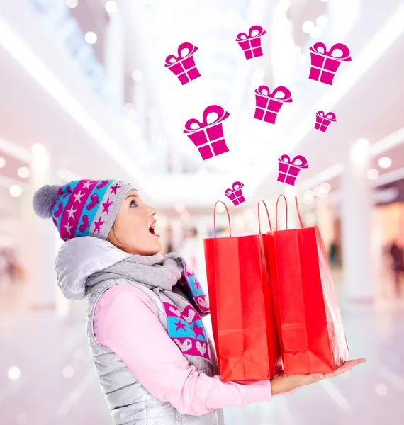 Surprised woman with gifts after shopping to the new year
