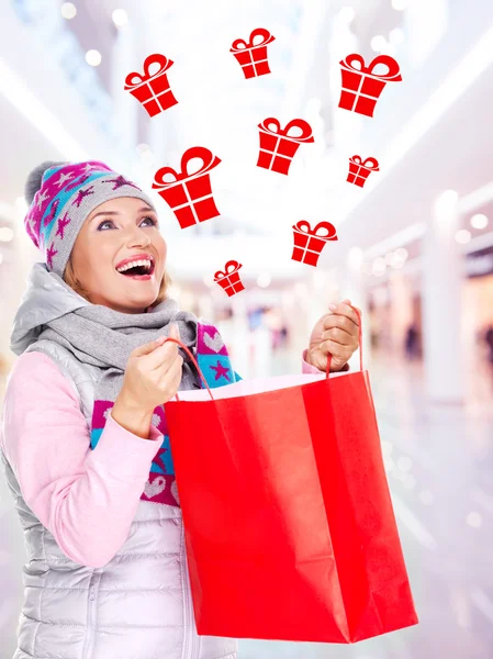 Woman with gifts after shopping to the new year at shop