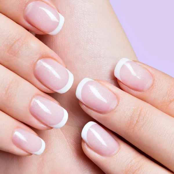 Woman's nails with beautiful french white manicure