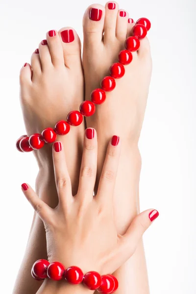 Closeup photo of a female feet with beautiful red pedicure