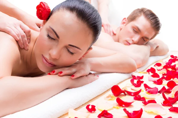 Couple lying in a spa salon enjoying back massage.