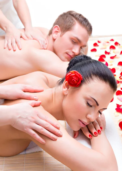 Couple lying in a spa salon enjoying back massage.