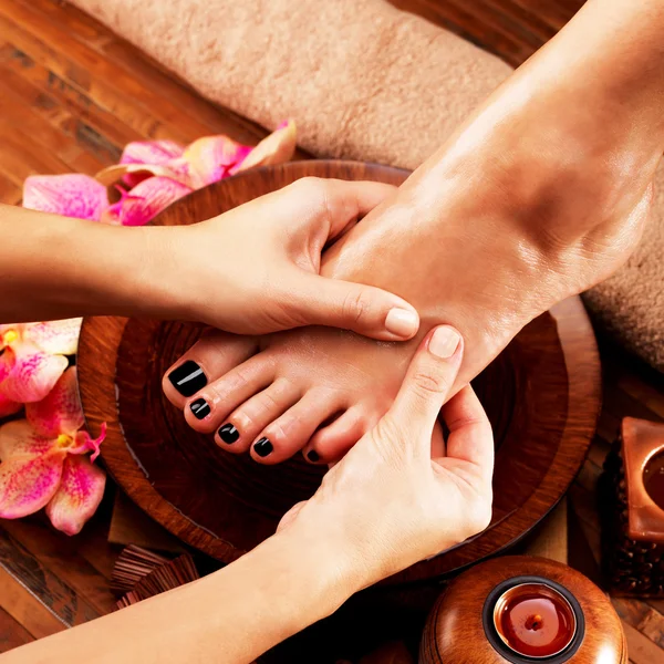 Massage of woman\'s foot in spa salon