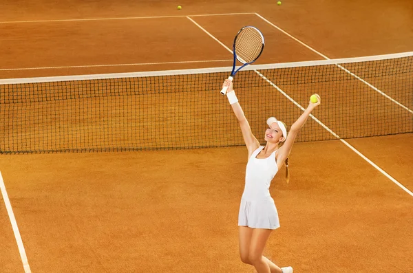 Female tennis player celebrating victory
