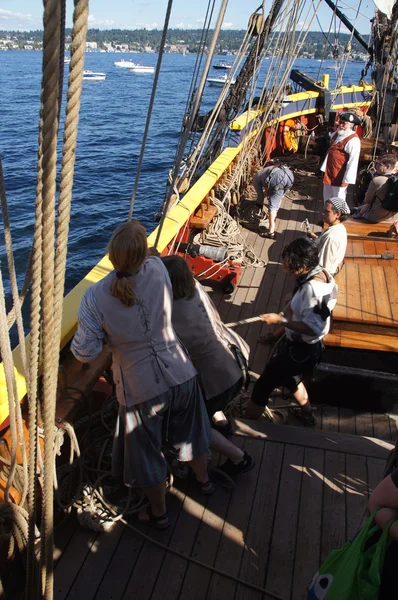 The crew sets the sails of the Lady Washington
