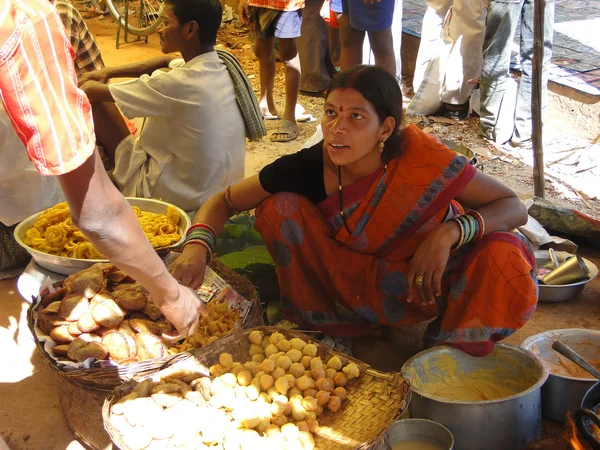 Woman prepares fried food for snacks