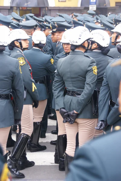 Female transit police watching a parade